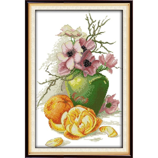Hibiscus vase and oranges